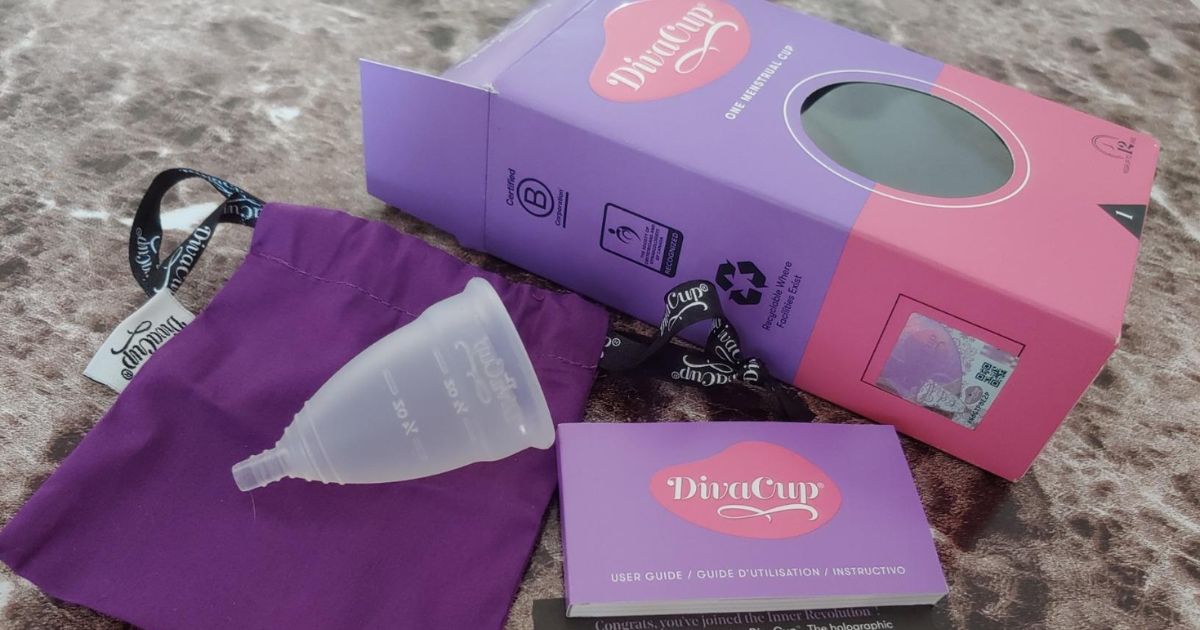 DivaCup box and contents laid out on a granite countertop