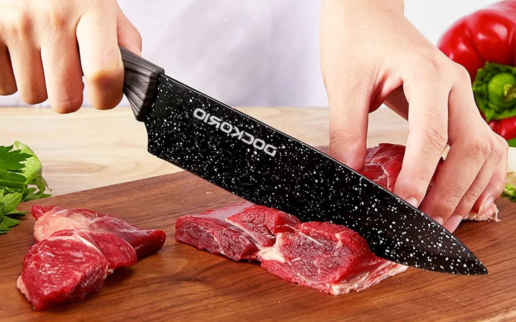 using black knife to cut meat