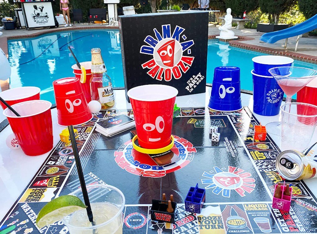 drink a palooza board game on table outside next to pool