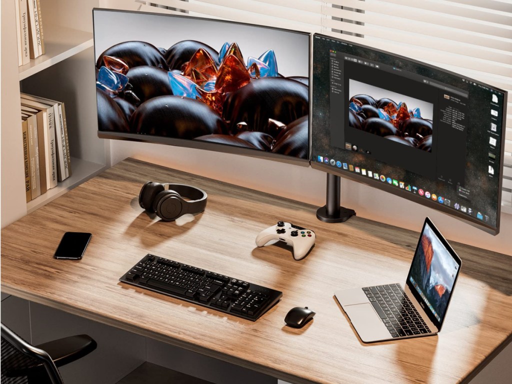 desk with two monitors raised on monitor stand