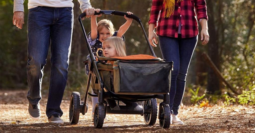 family pushing stroller with toddler in it