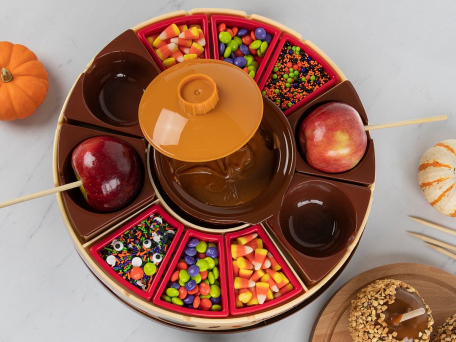 Fondue melter with apples and items on the tray