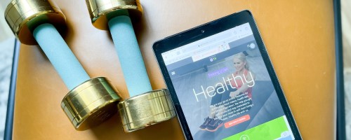 Get Healthy on tablet next to weights