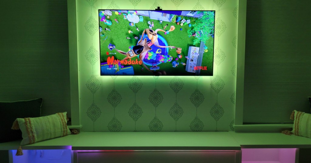 TV on wall in home with green backlights