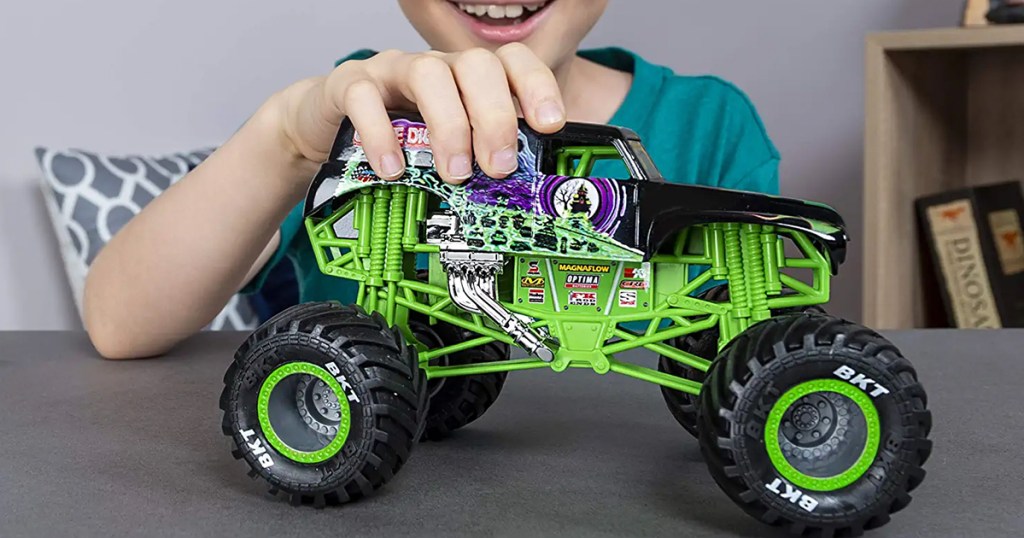 kid playing with grave digger RC truck