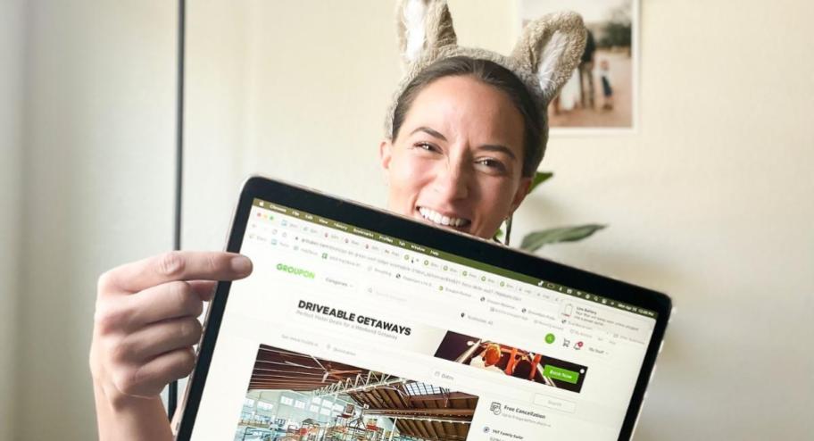 woman pointing to laptop screen and wearing wolf ears