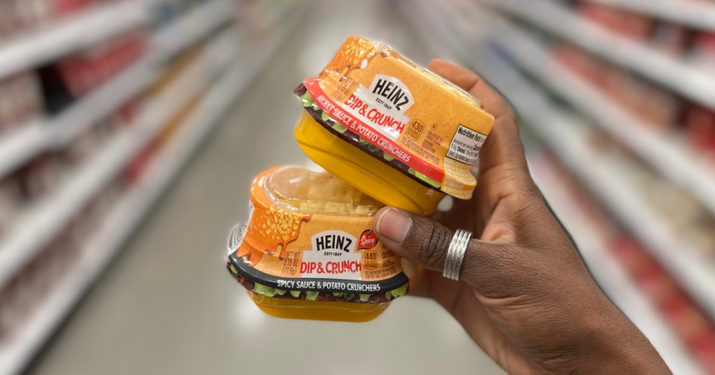hand holding two burger sauce cups in store