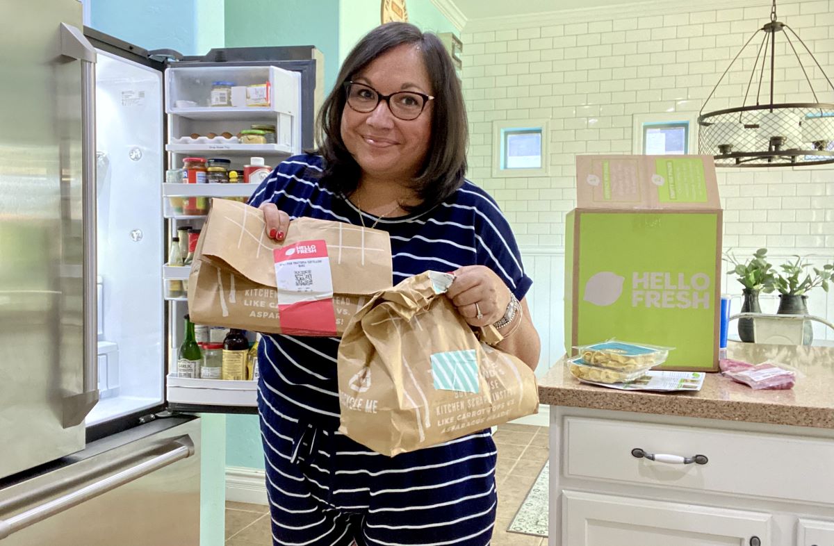 woman holding Hello Fresh Meal bags