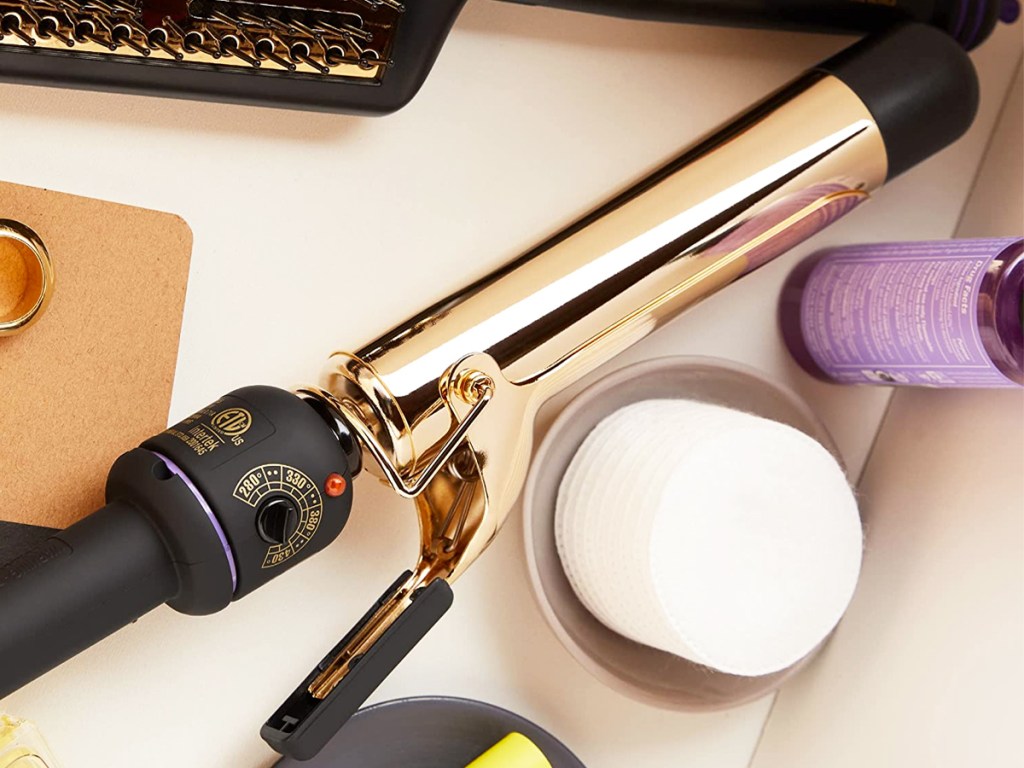 black and gold curling wand in bathroom drawer