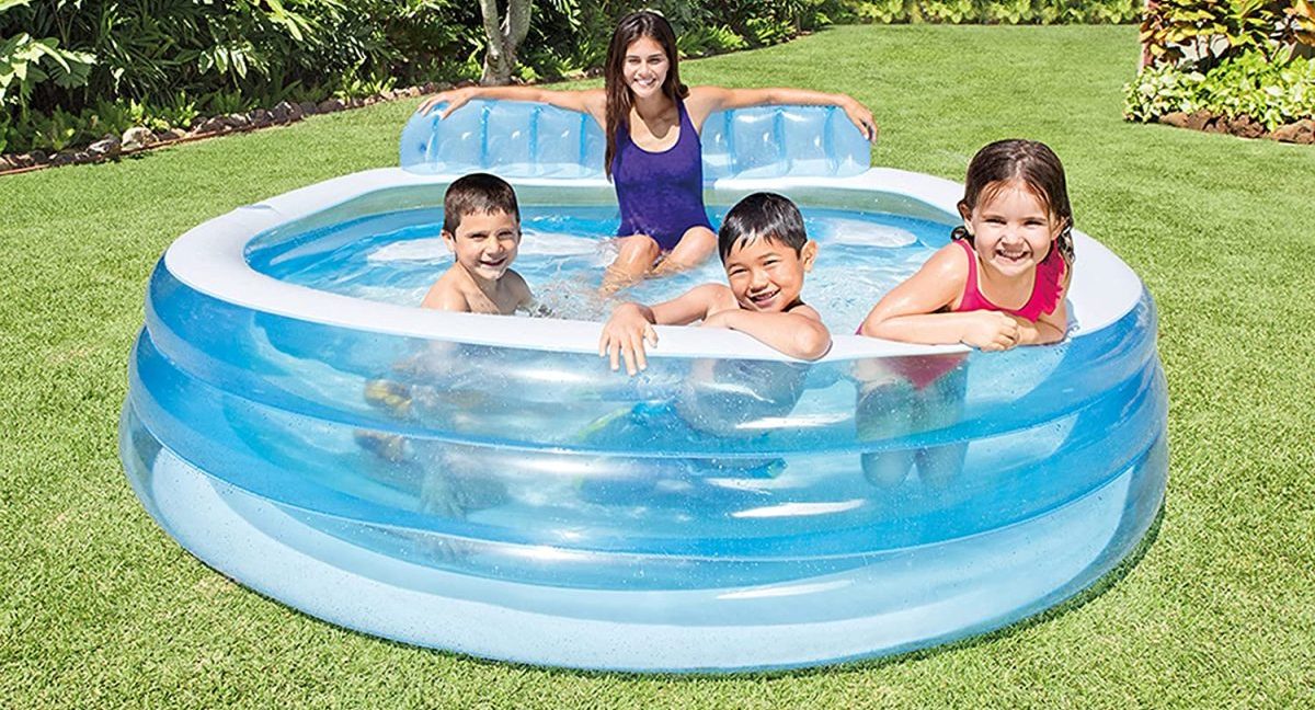 mom in round inflatable pool with 3 kids