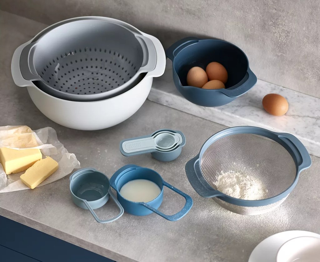 Mixing bowls and measuring cups with ingredients in them on the counter