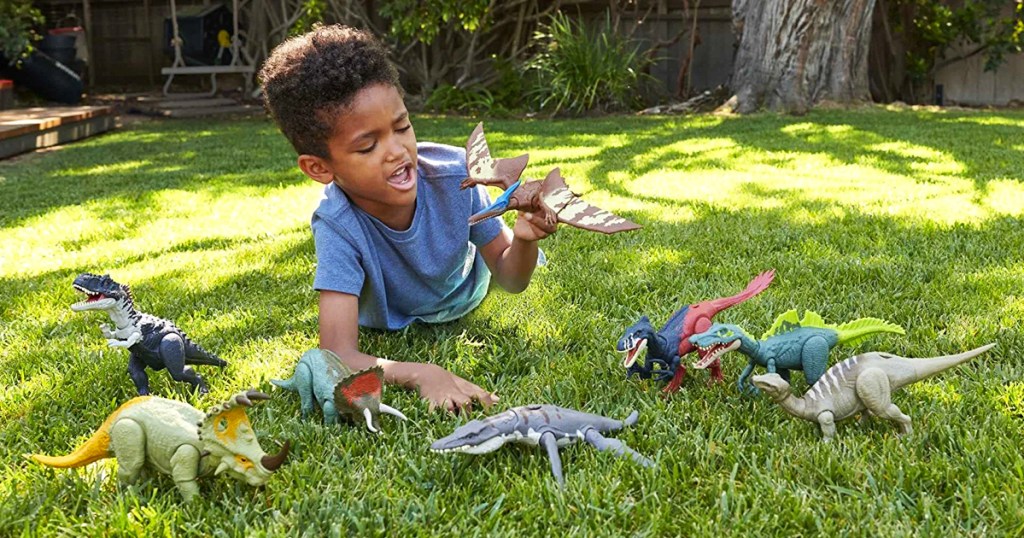 boy playing with dinosaur toys