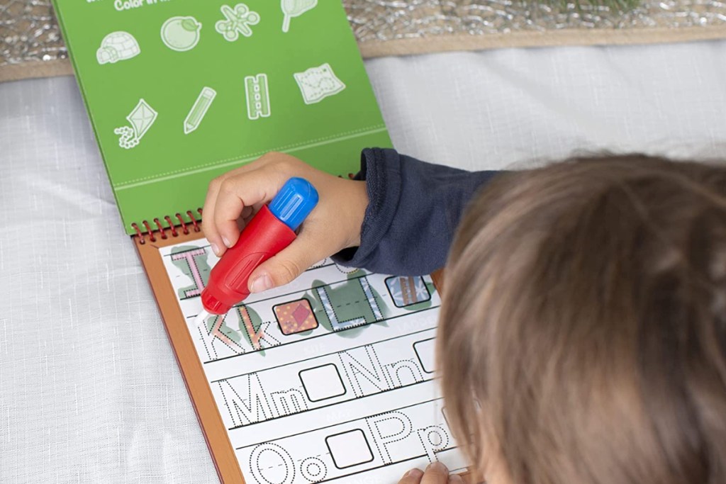 Kid coloring on Melissa and Doug Wow Pad