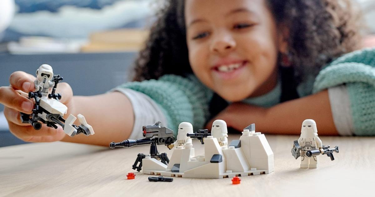 young girl playing with the LEGO Star Wars Snowtrooper Battle Pack