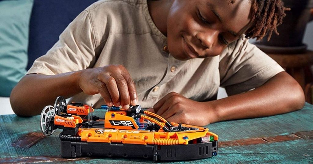 boy playing with a LEGO Technic Rescue Hovercraft