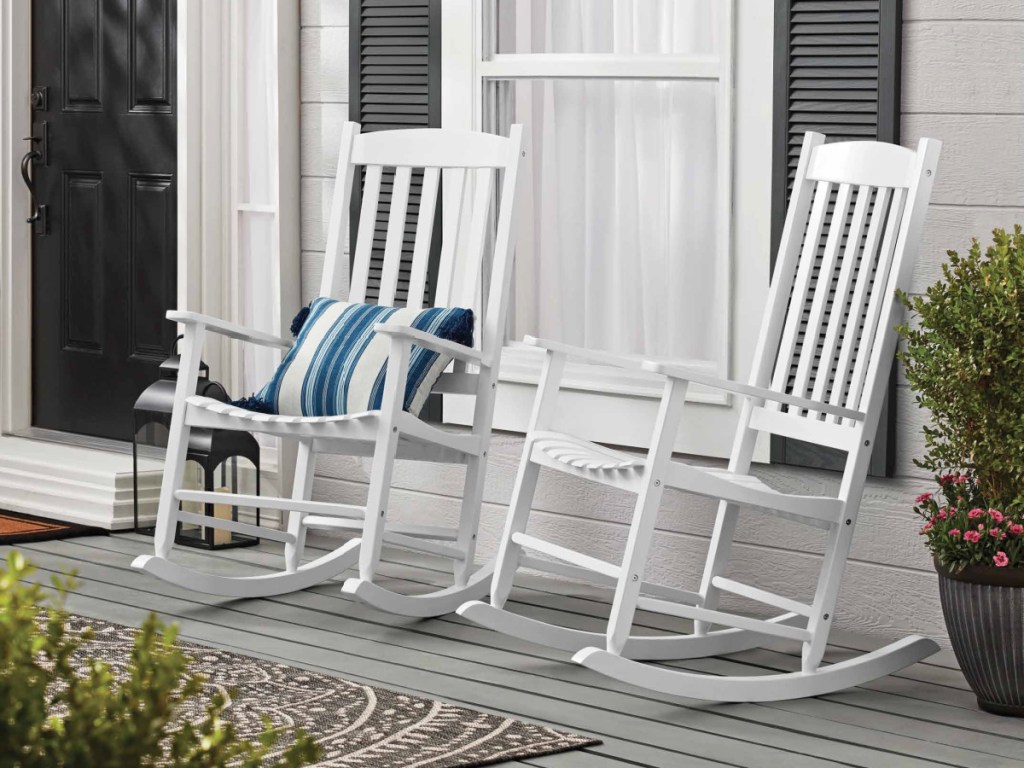 two white rocking chairs on outdoor porch