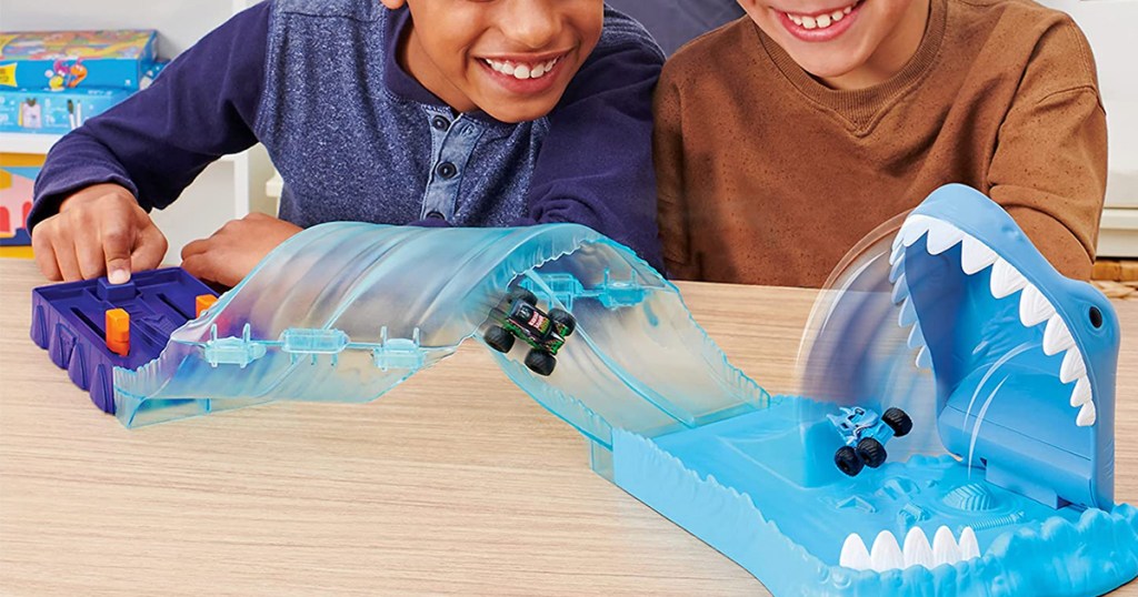 two kids playing with monster truck toy