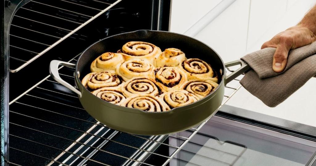 ninja pan full of cinnamon rolls coming out of oven