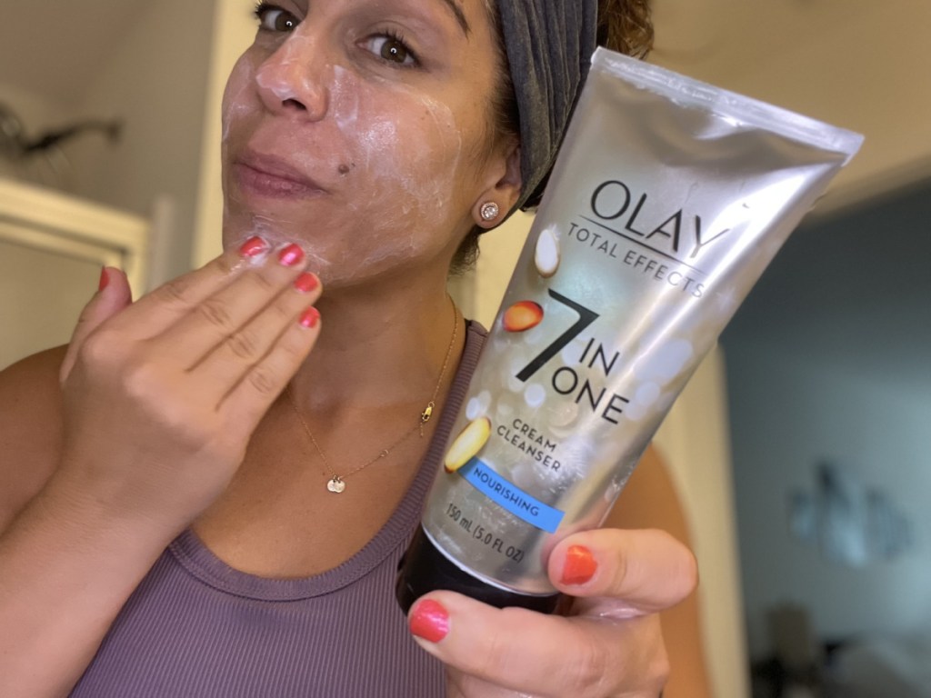 Woman washing face with Olay 7 in One Cleanser