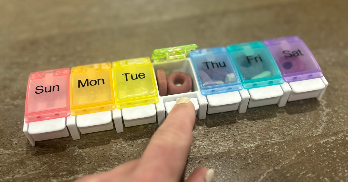 multi colored pill organizer on tabletop filled with pills