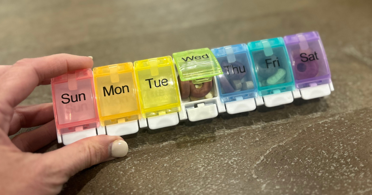 woman holding up Pill Organizer with days of the week