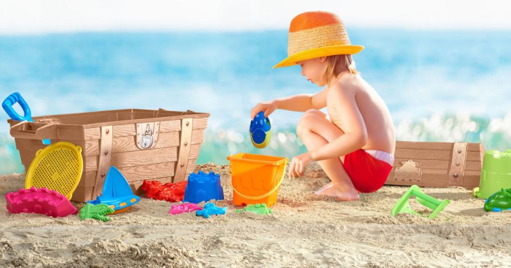 kid with sand toys and toy chest