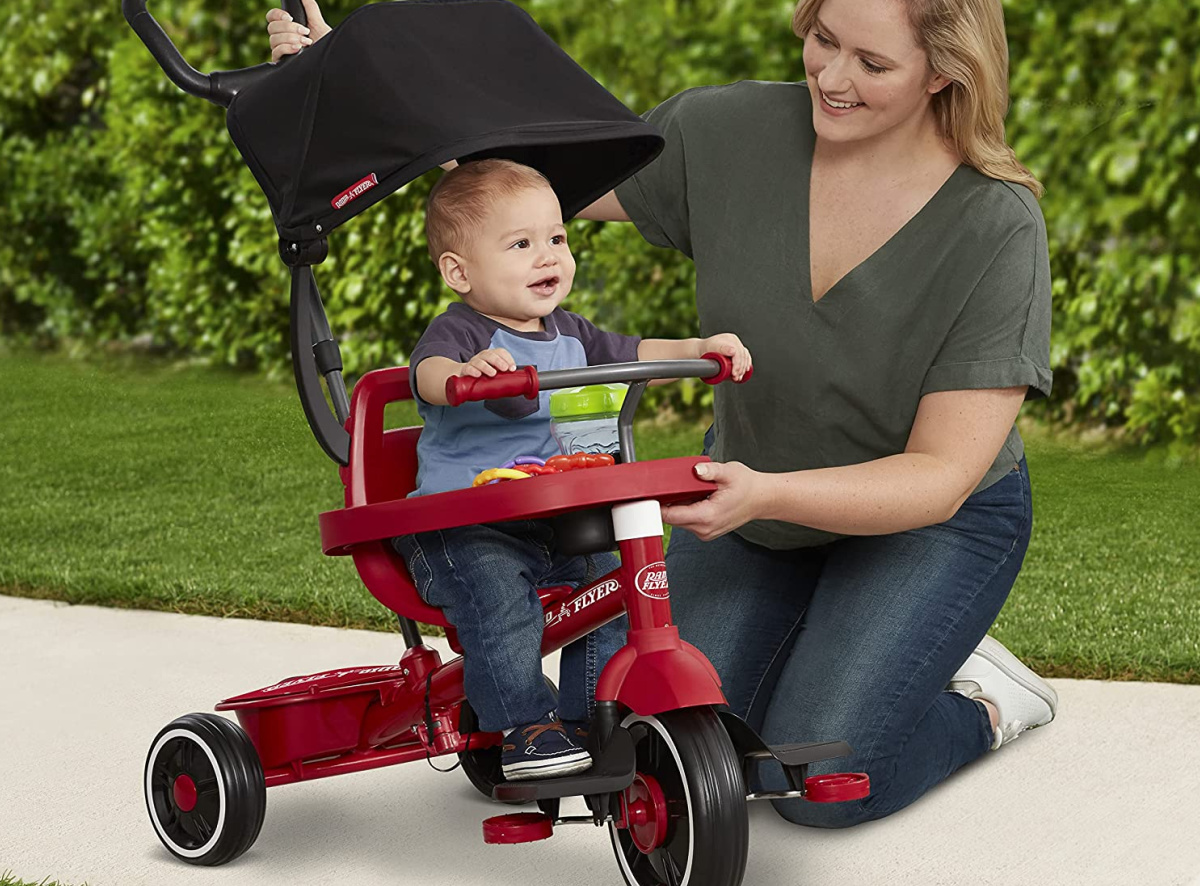 Mom next to Radio Flyer bike with baby inside