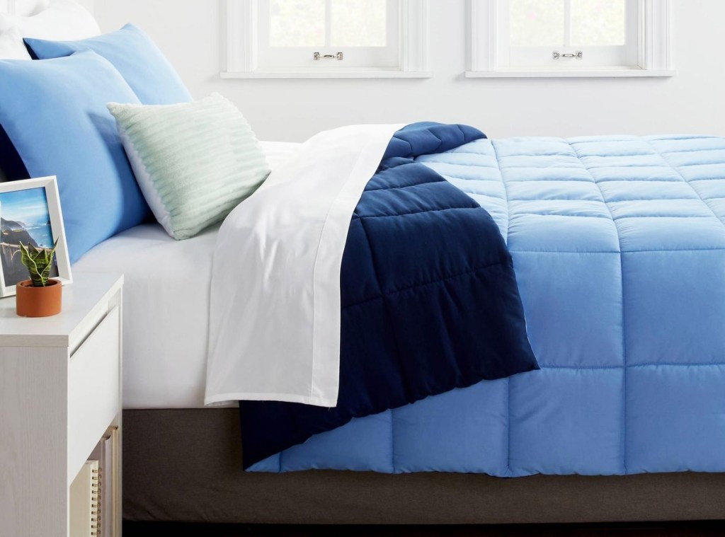 blue reversible comforter on bed