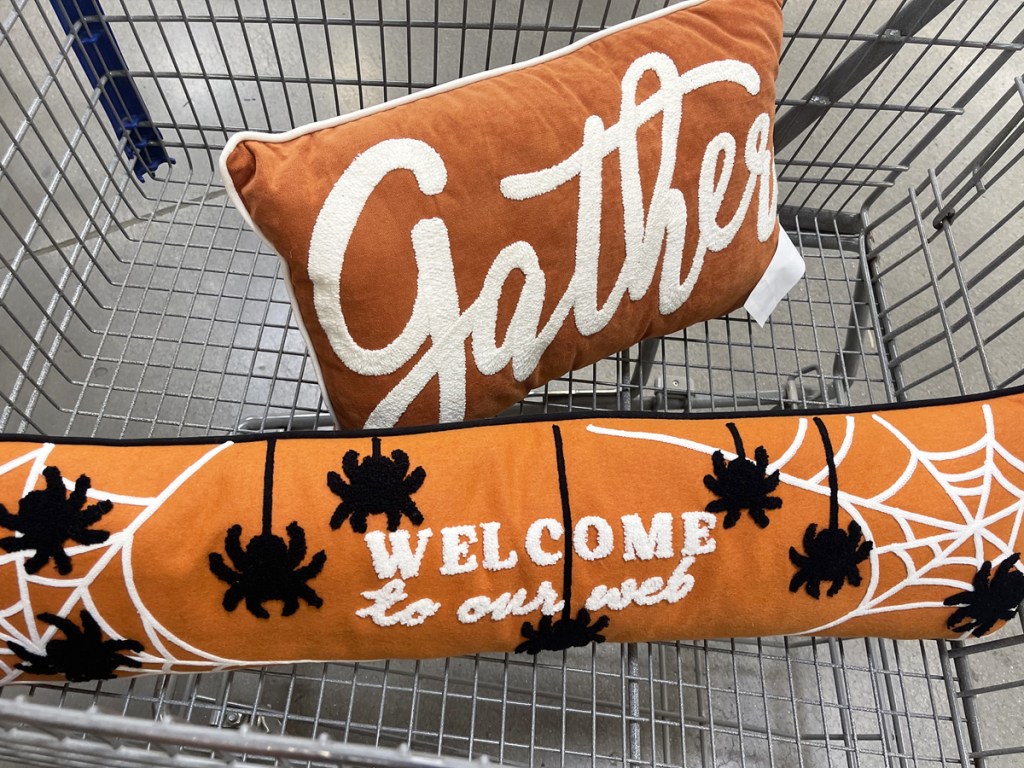 throw pillows in shopping cart that say "gather" and "welcome to our web"
