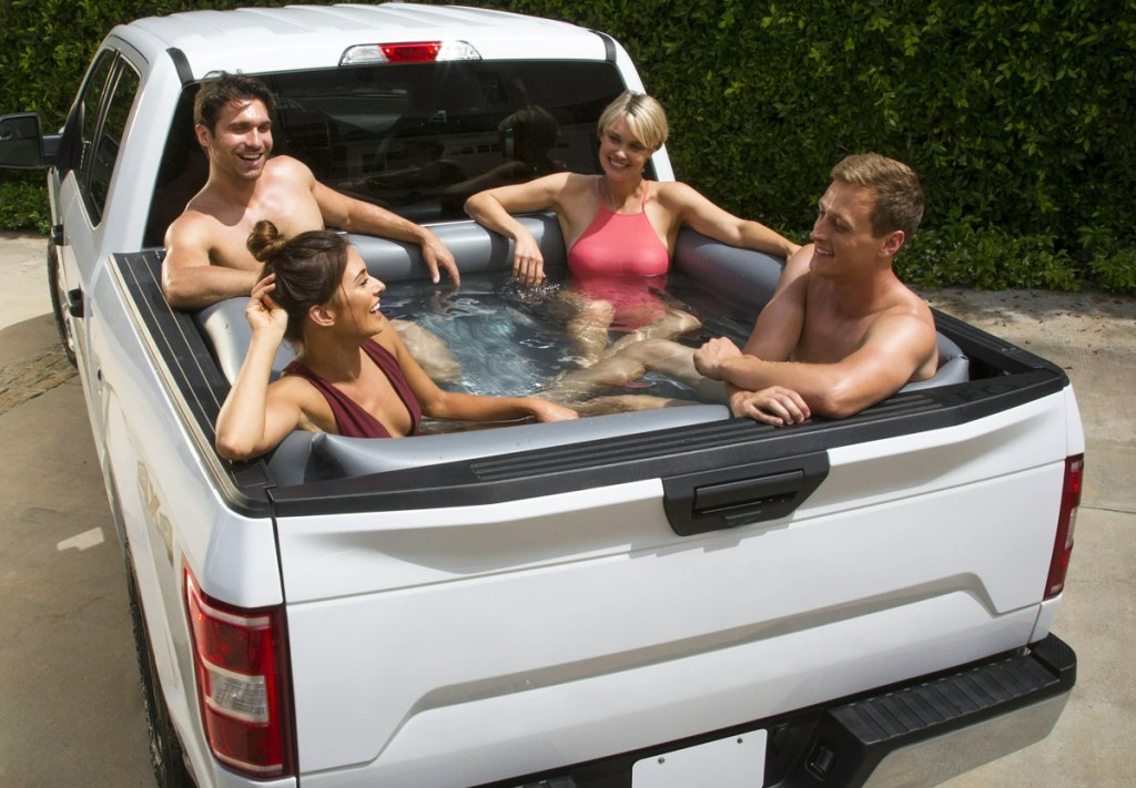 group of people in pool inside a truck bed