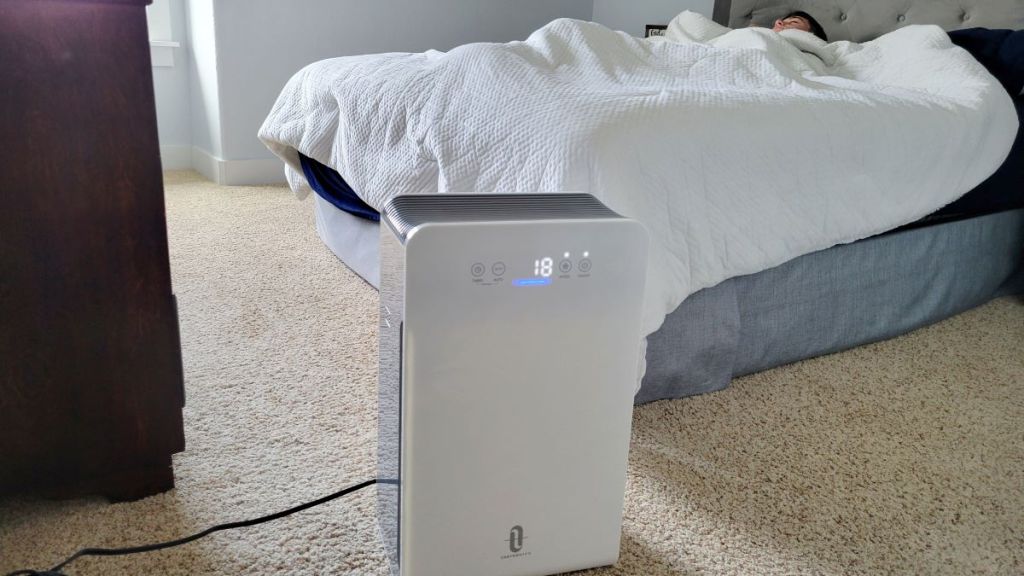 Taotronics air purifier by a bed