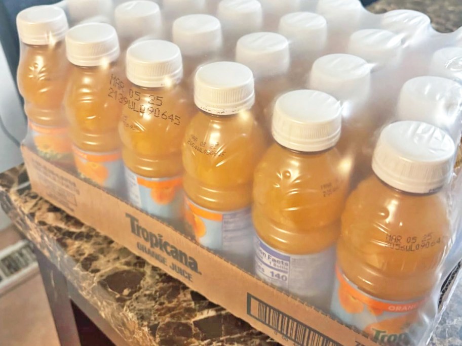 case of Tropicana juice bottles on table