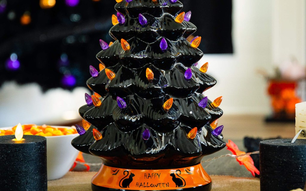 black ceramic Halloween tree with orange and purple lights on table
