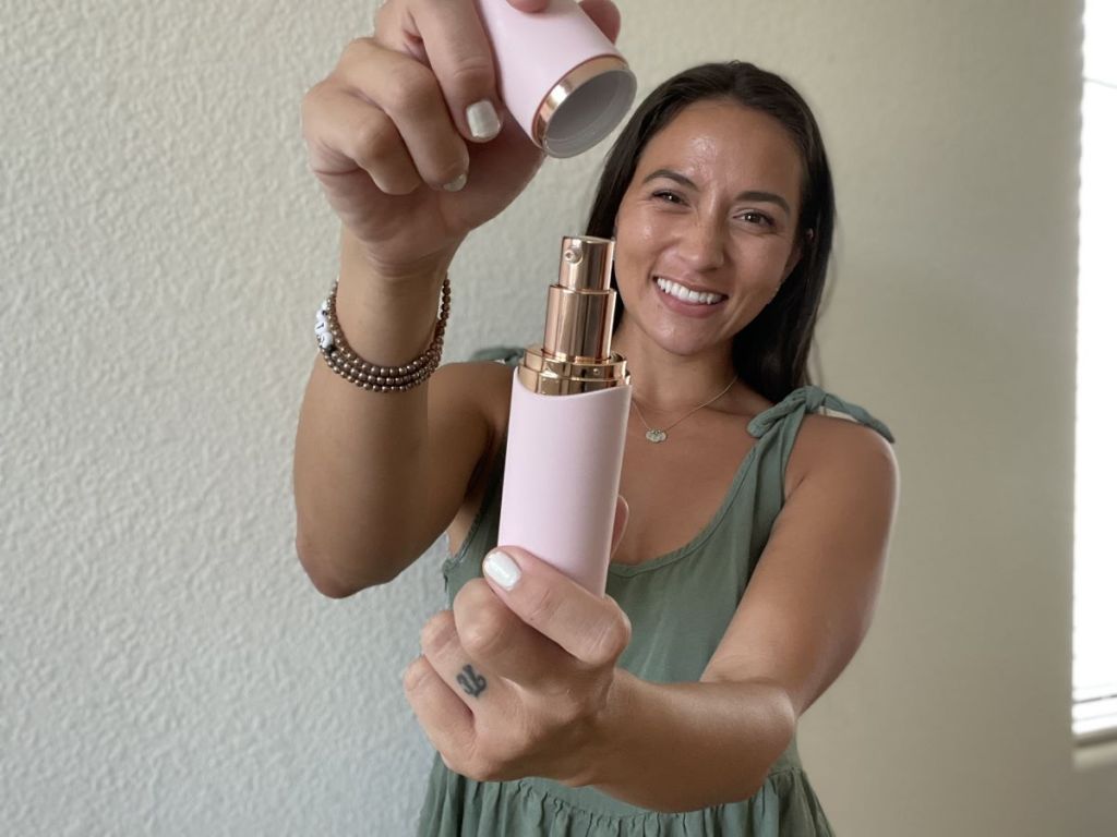 woman holding a Winky Lux Tinted Moisturizer