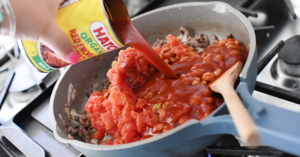 adding enchilada sauce to chili