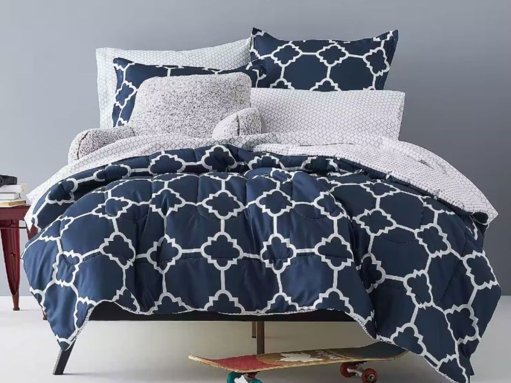 blue and white patterened bedding on bed