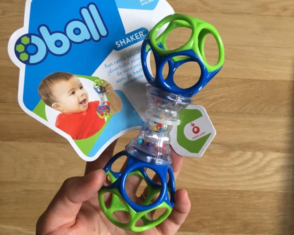 holding a baby rattle in the package