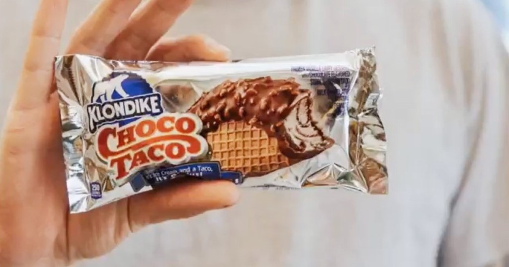 holding a packaged Choco Taco