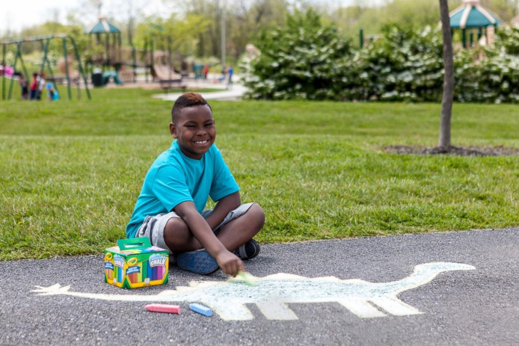 boy drawing with crayola sidewalk chalk