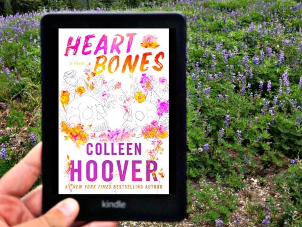 holding a Kindle showing the cover of Heart Bones