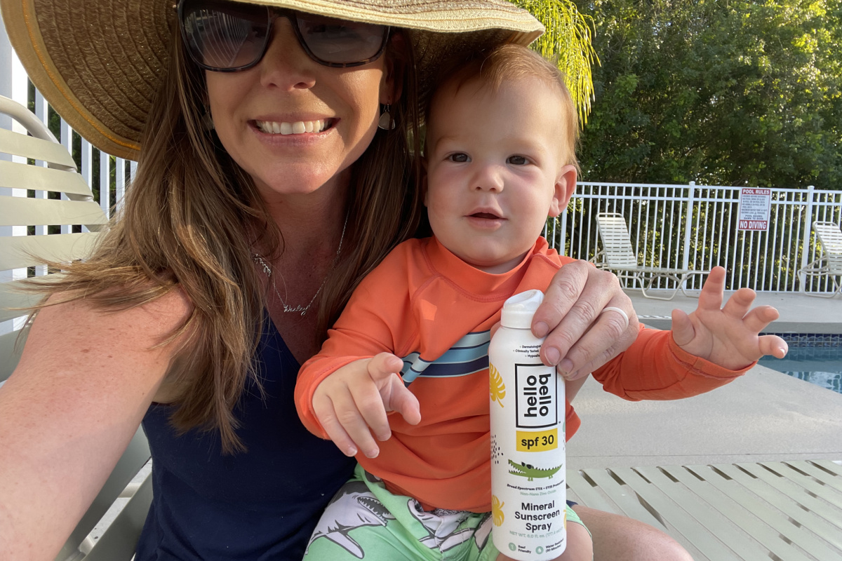 woman & baby holding sunscreen