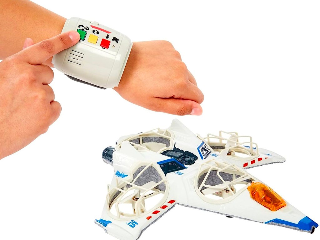 childs wrist with wrist toy and rc hot wheels lightyear plane