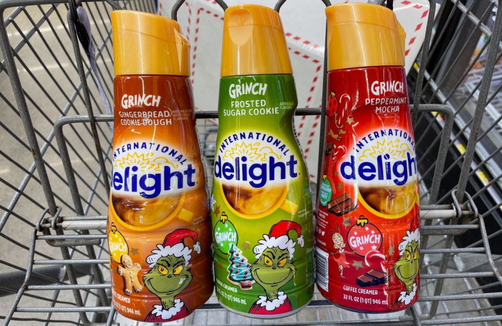 international delights grinch coffee creamer bottles in a shopping cart