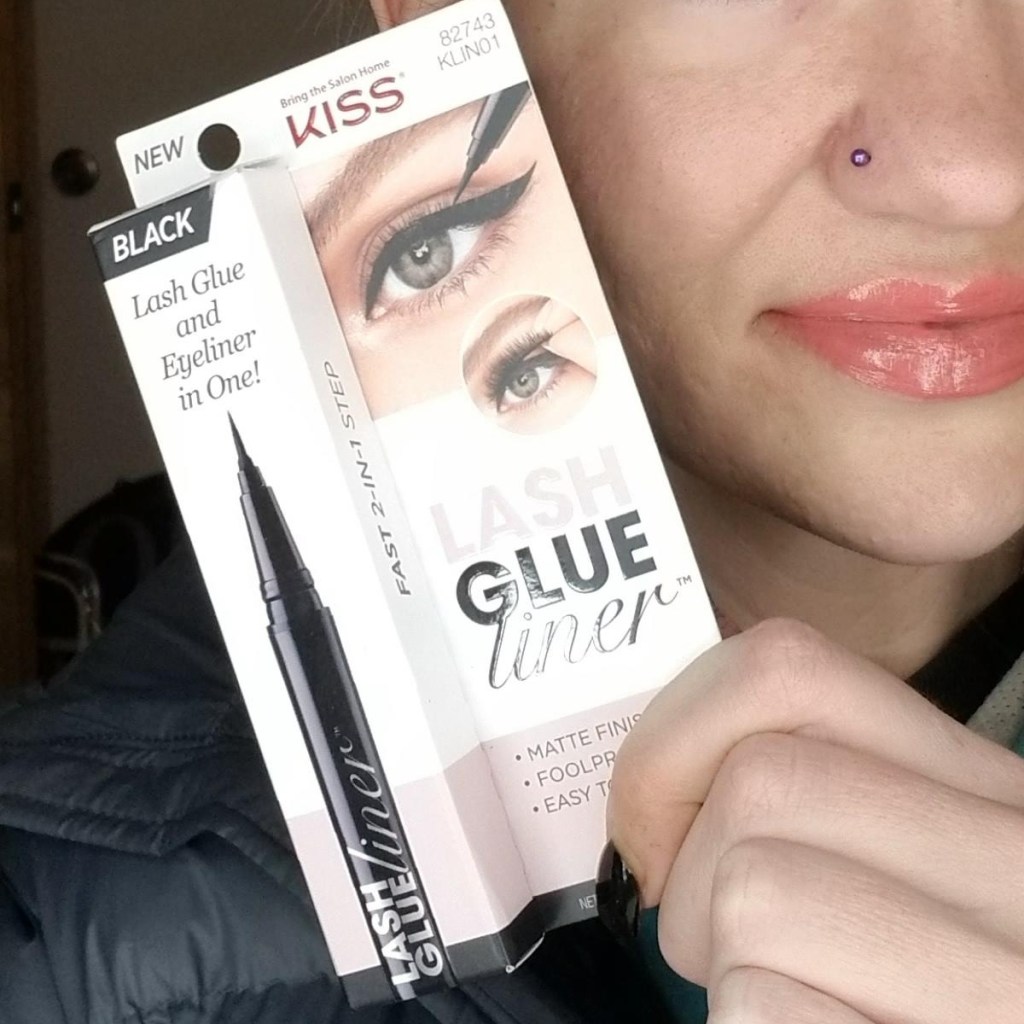woman holding package of lash glue eyeliner