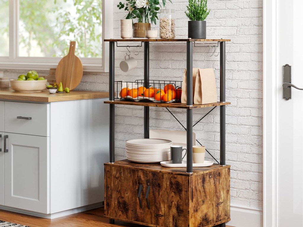 metal and wood storage shelf with stack of white plates and fruit containers