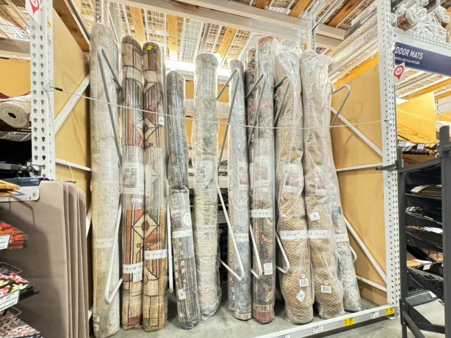 large 8x10 area rugs at Lowe's rolled up on a shelf