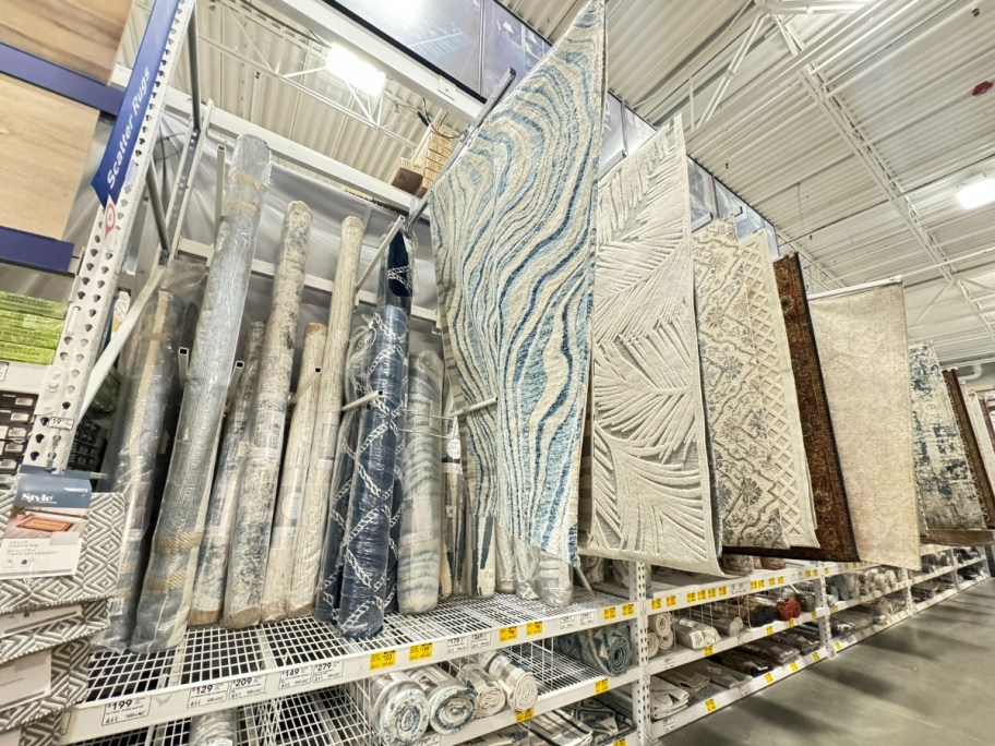 area rugs on display at Lowe's - some rolled up, some hanging open on display