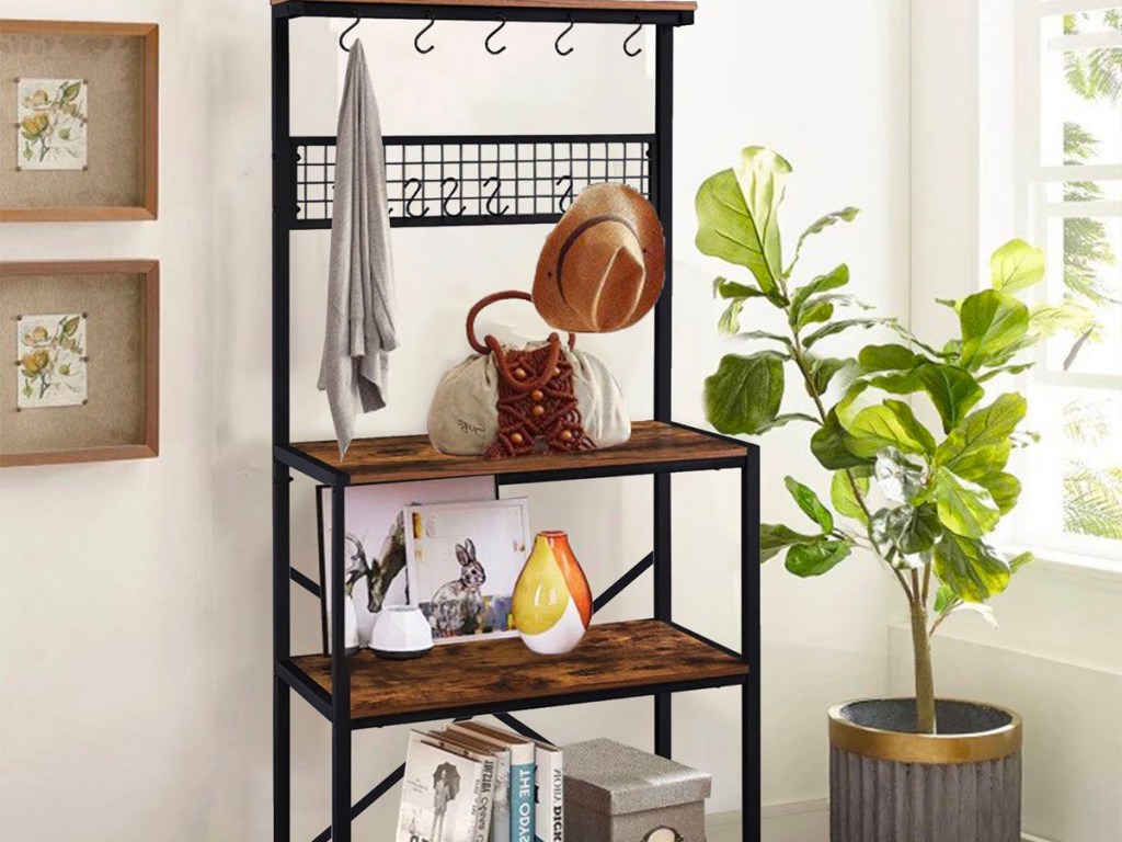 metal and wood shelf with hat and sweater hanging on it