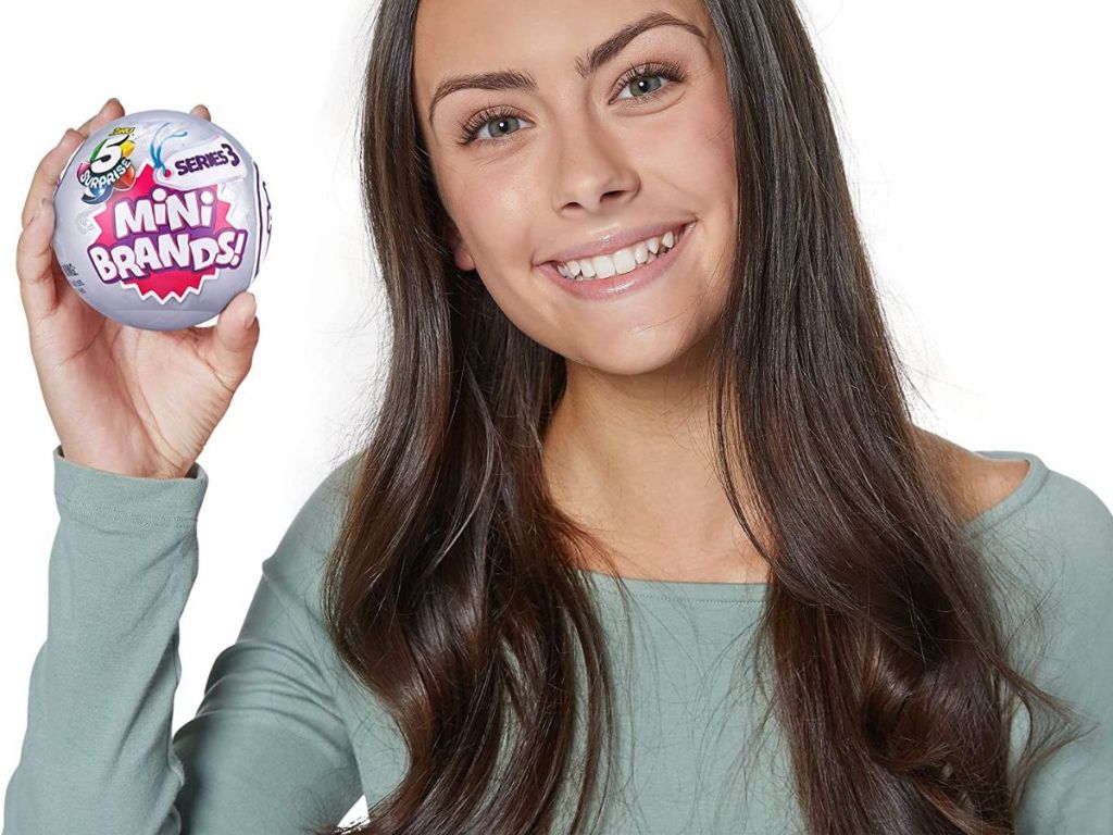 girl holding up Mini Brands