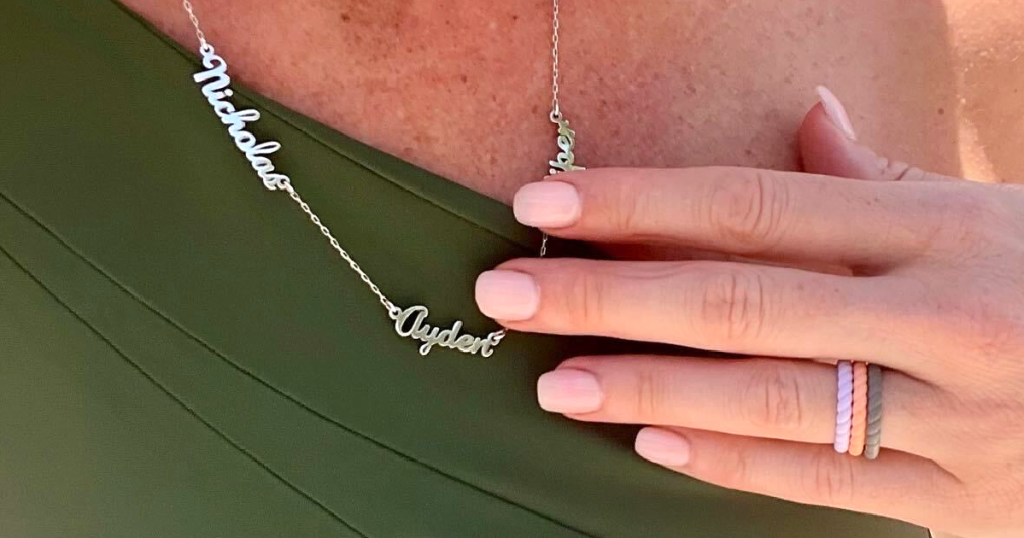 holding name necklace 
